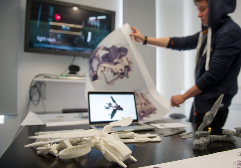 A person focused on a detailed model of a project.